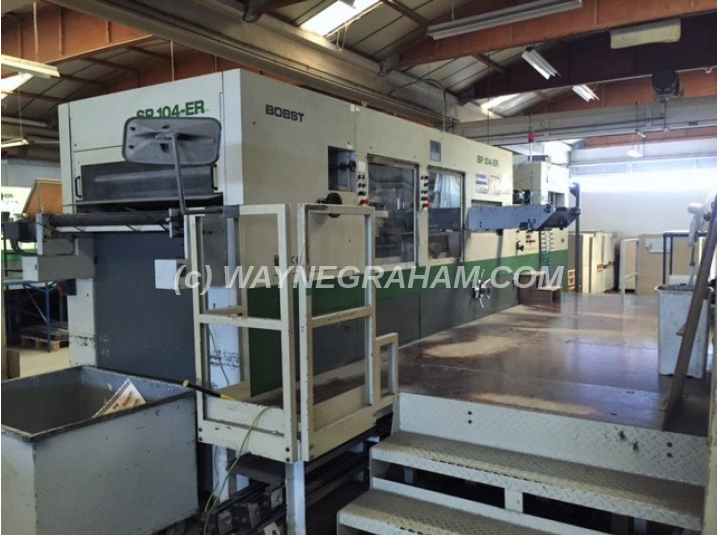 Image of a used Bobst SPeria 104-ER Die Cutting Machine with both Stripping and Blanking Stations For Sale - Year: 2001 - Equipped with: Stripping Station, Blanking Station, CUBE, Micrometric, Non-Stop Feeder, Makeready Table - Ref: 32197